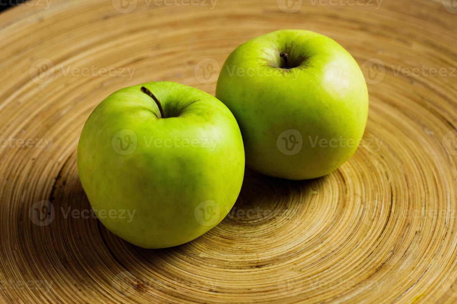 Apple on beatiful wooden tray laying side by side photo