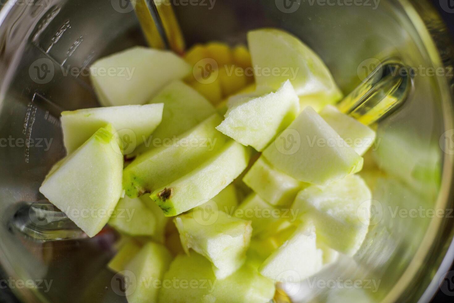 Green apple in Blender for smoothie preparation photo