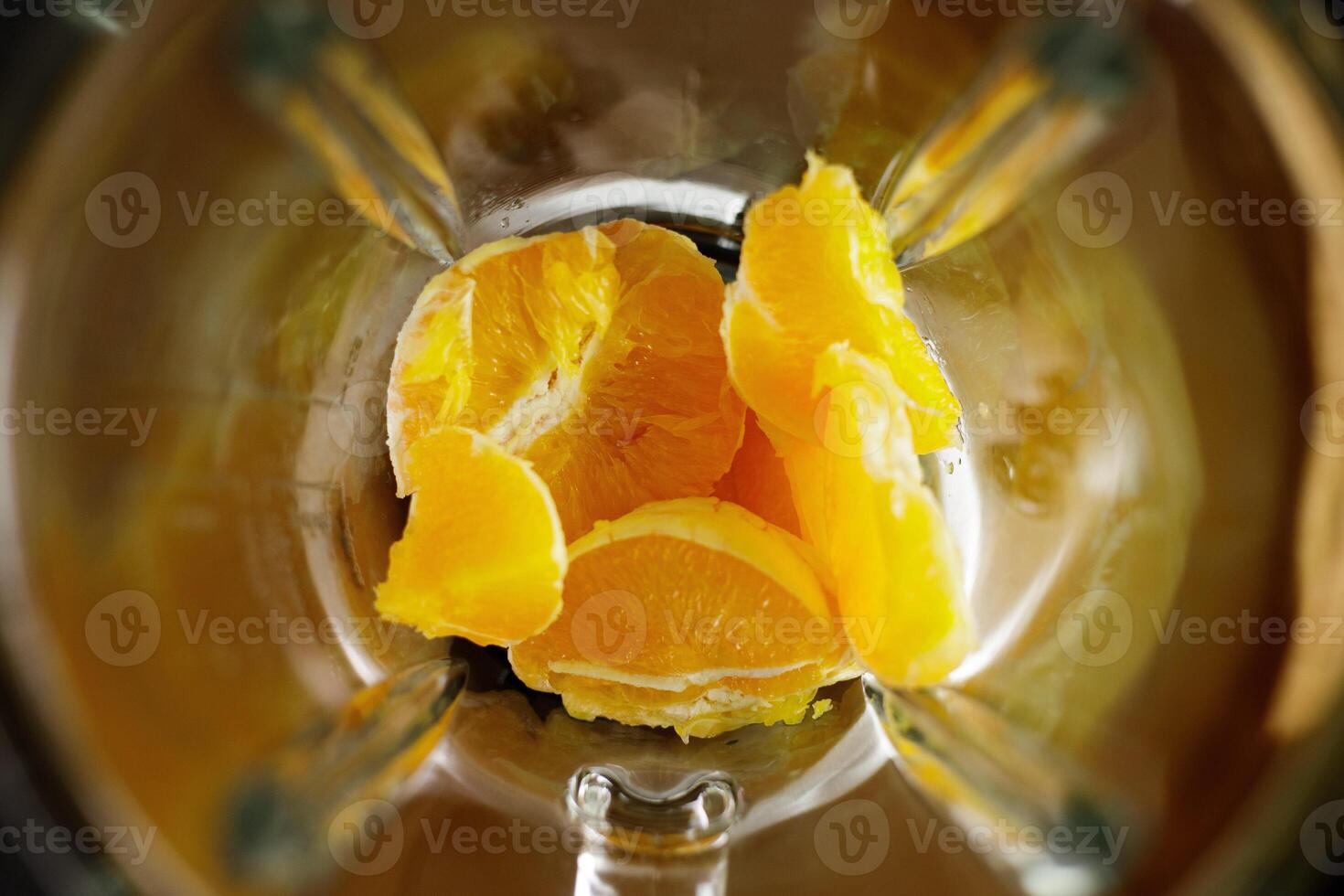 Orange slices in blender prepared for smoothie making photo