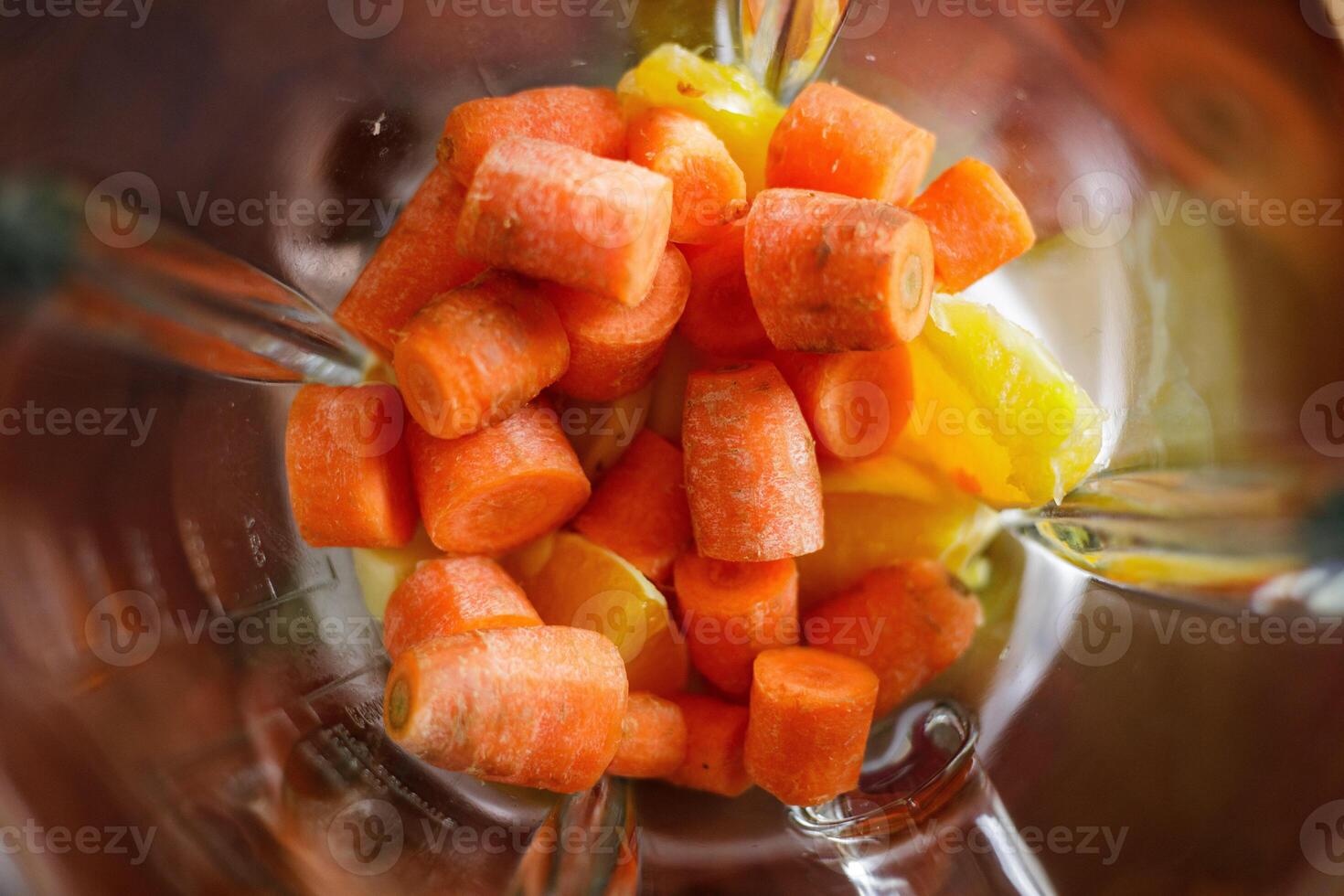 Carrot in blender being prepared for smoothie making photo