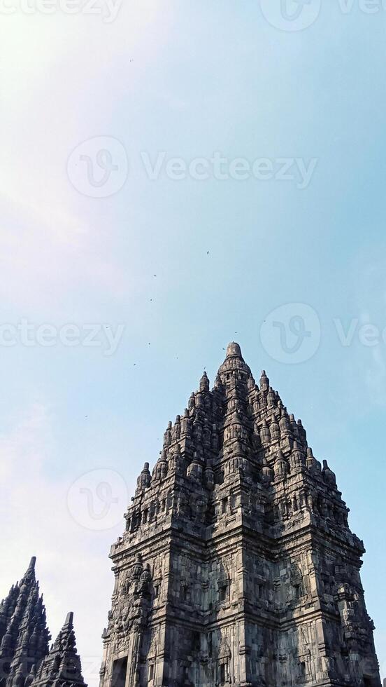 Prambanan temple with bright blue clouds photo