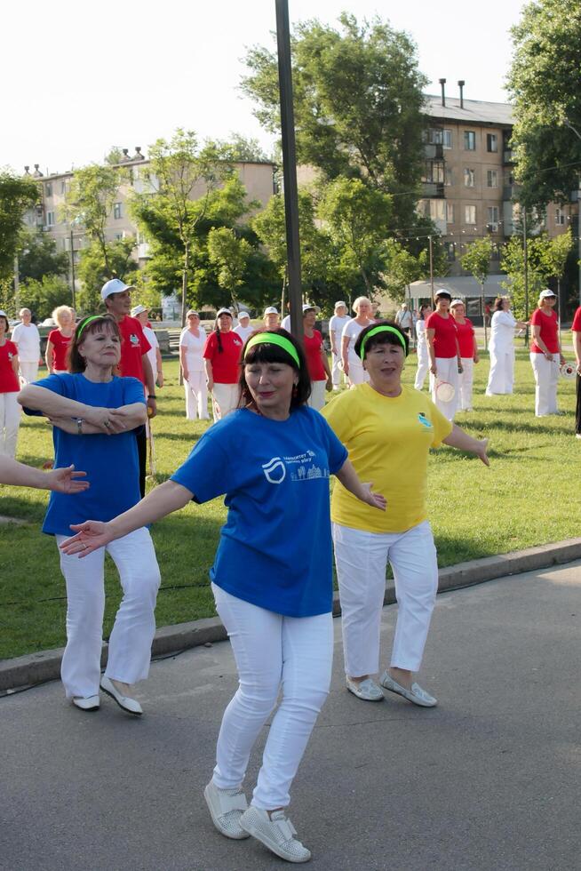 dniéper, Ucrania - 21.06.2021 un grupo de mayor personas haciendo salud y aptitud gimnasia con un pelota en el parque. foto