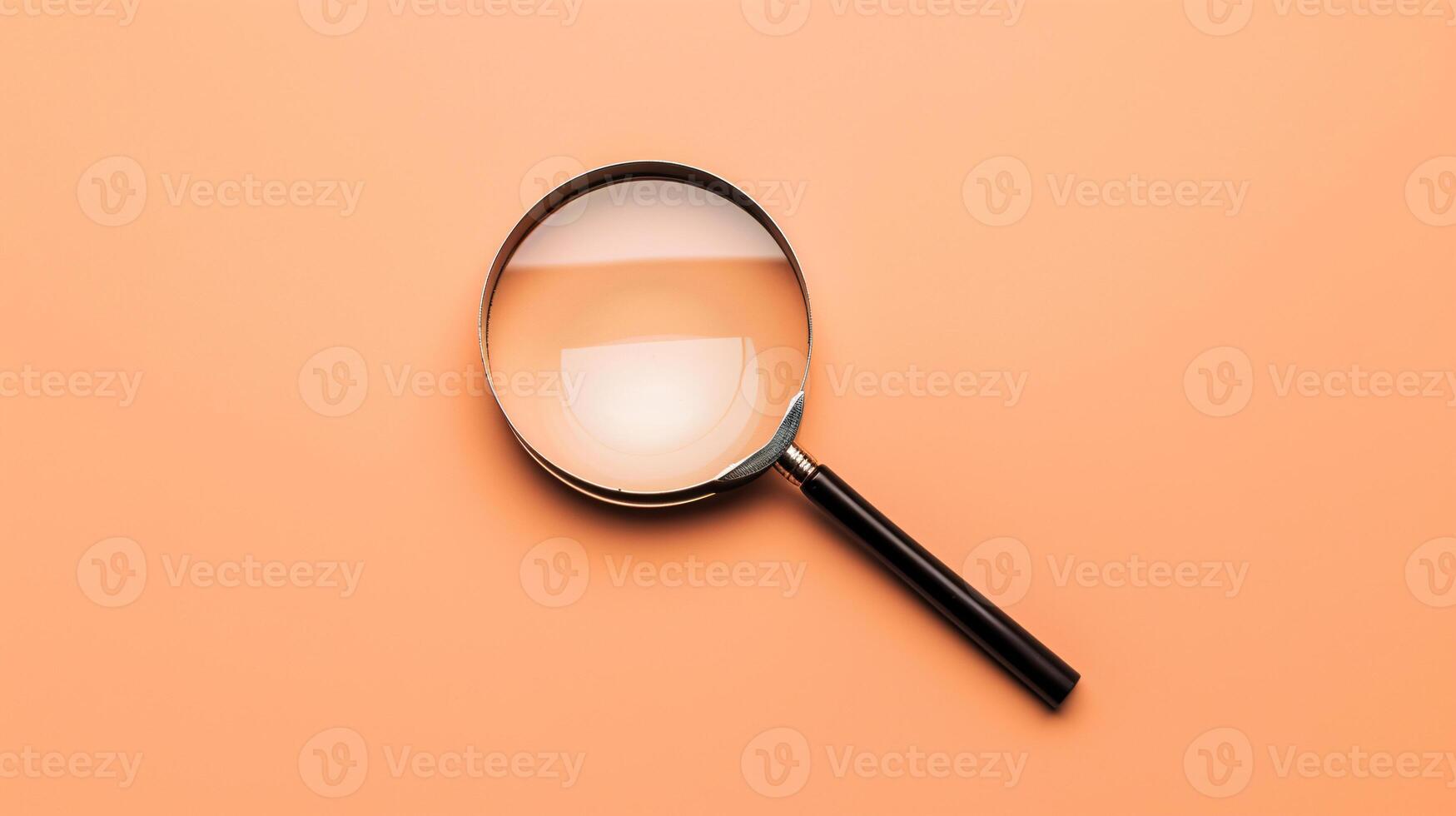 A single antique magnifying glass, placed against a muted colored background, symbolizes curiosity and discovery photo