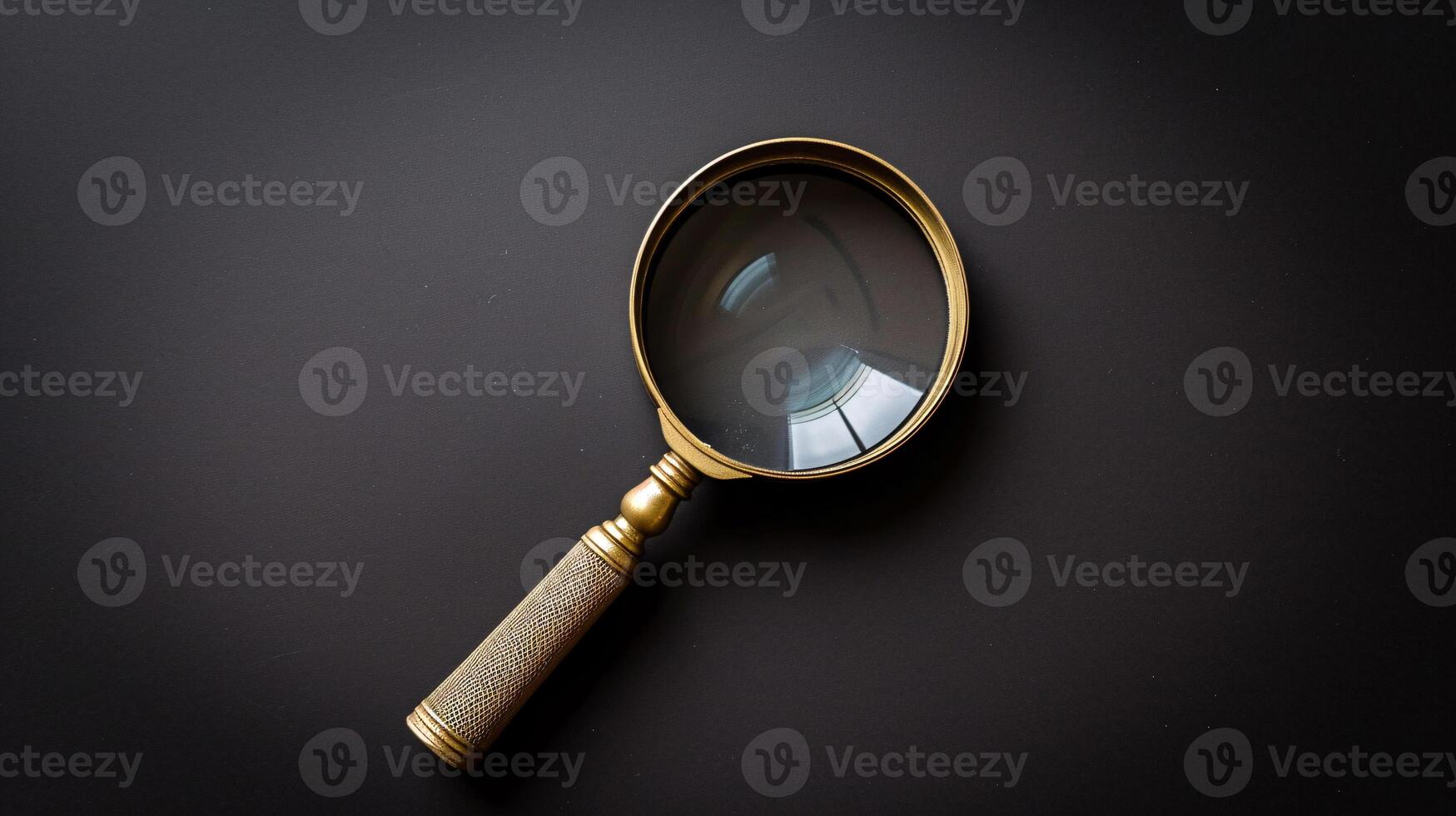 A single antique magnifying glass, placed against a muted colored background, symbolizes curiosity and discovery photo