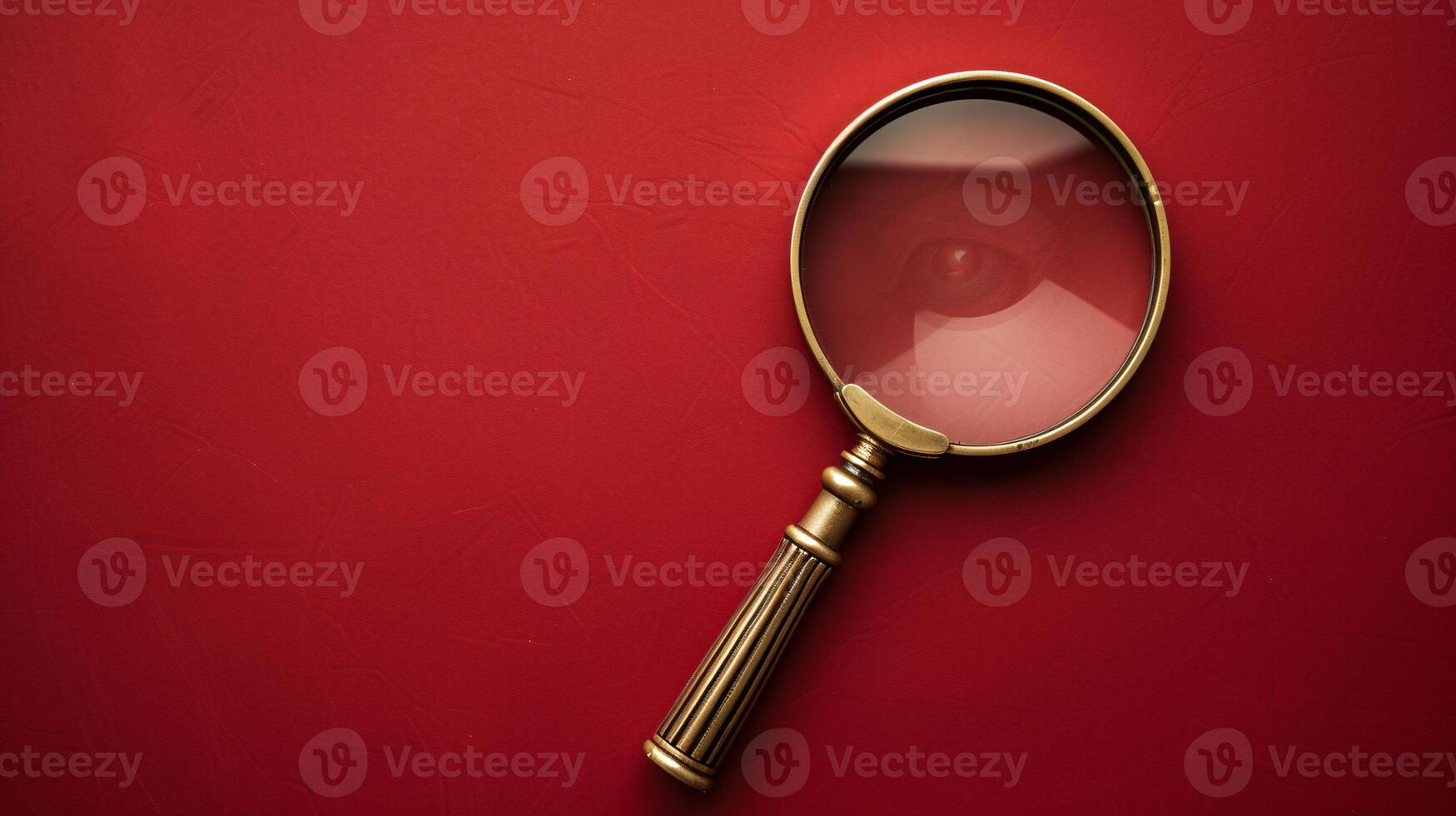 A single antique magnifying glass, placed against a muted colored background, symbolizes curiosity and discovery photo