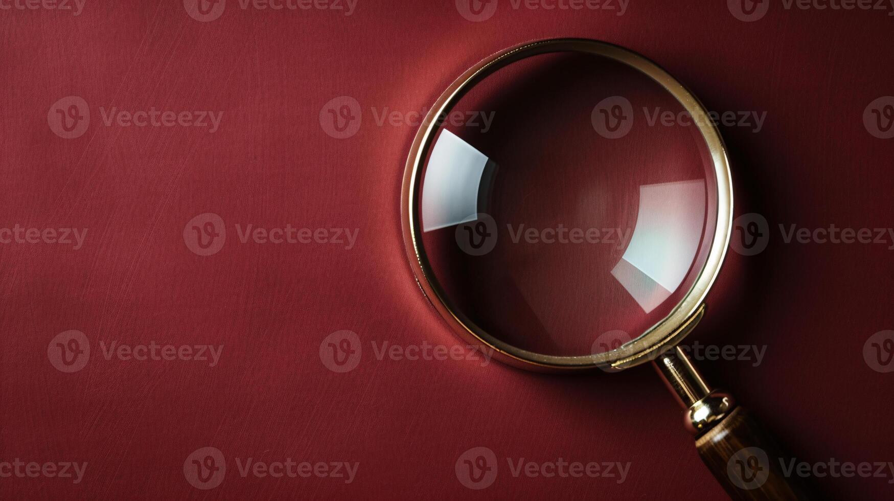 A single antique magnifying glass, placed against a muted colored background, symbolizes curiosity and discovery photo