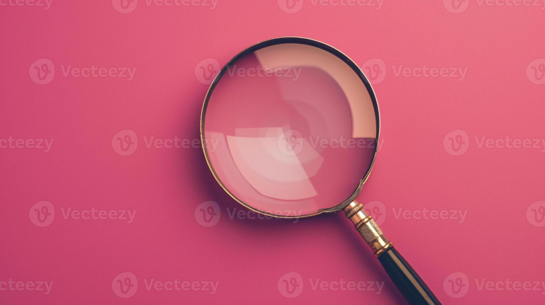 A single antique magnifying glass, placed against a muted colored background, symbolizes curiosity and discovery photo