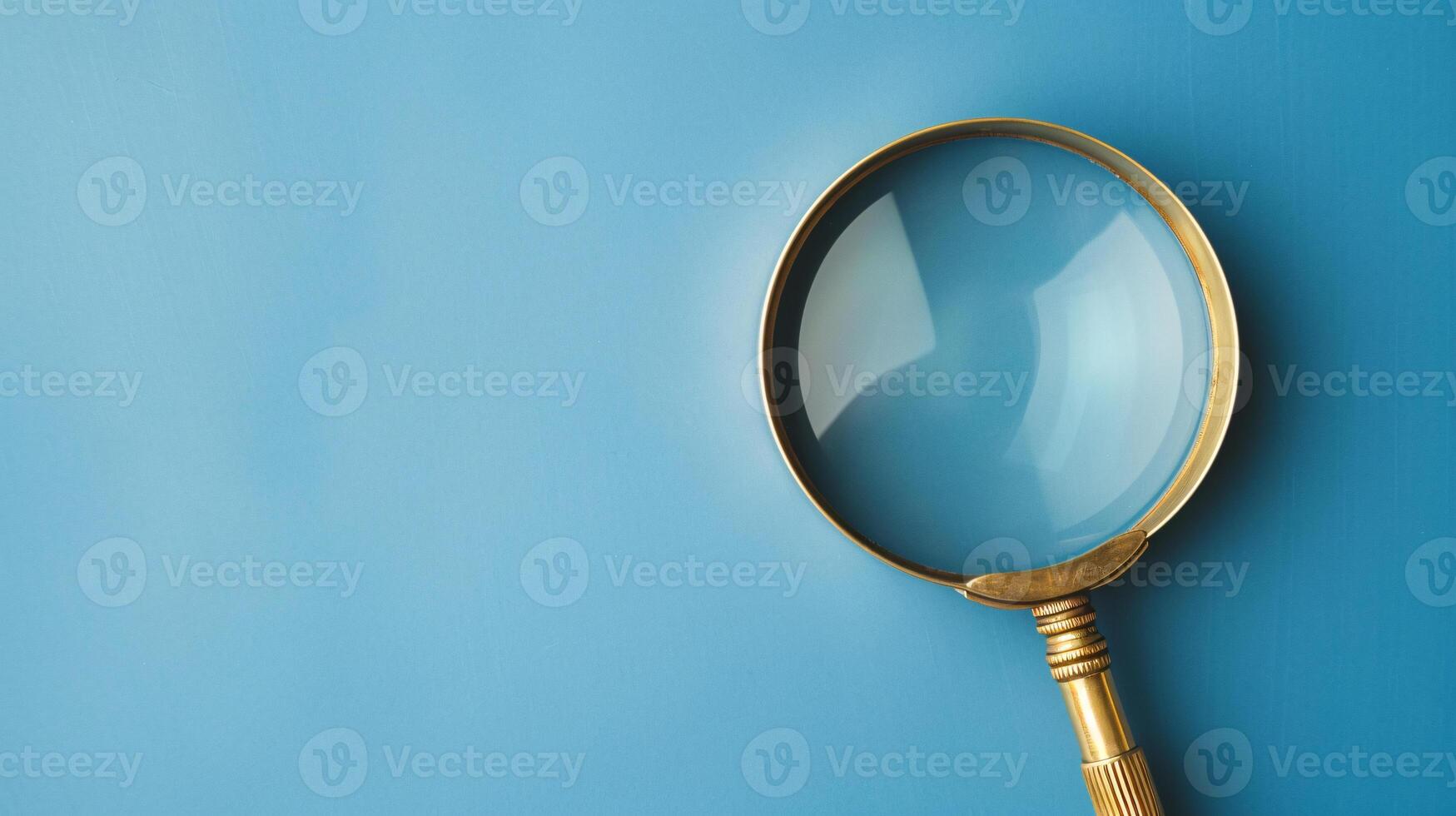 A single antique magnifying glass, placed against a muted colored background, symbolizes curiosity and discovery photo