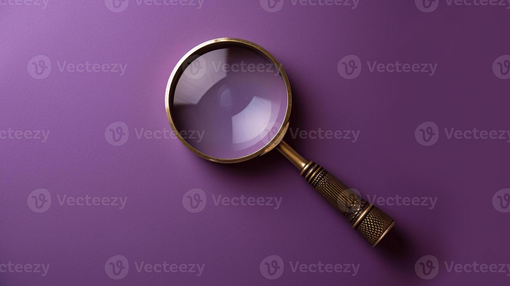 A single antique magnifying glass, placed against a muted colored background, symbolizes curiosity and discovery photo