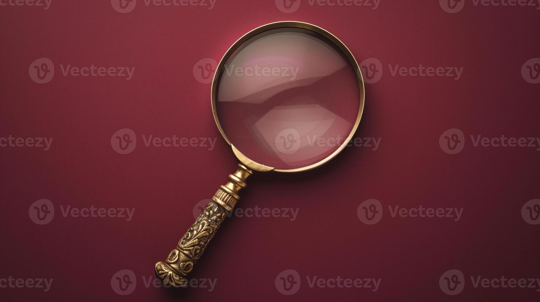 A single antique magnifying glass, placed against a muted colored background, symbolizes curiosity and discovery photo