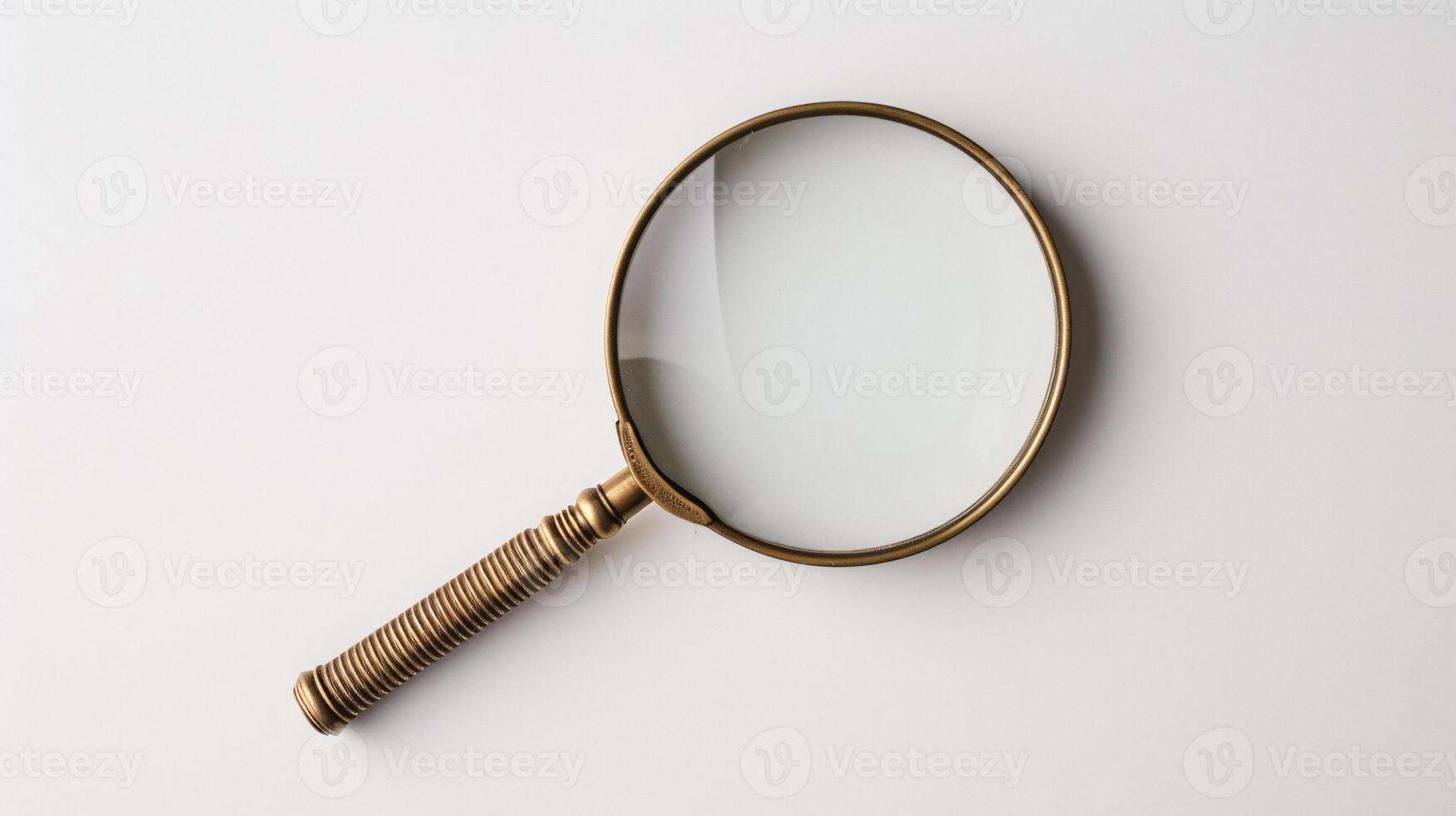 A single antique magnifying glass, placed against a muted colored background, symbolizes curiosity and discovery photo