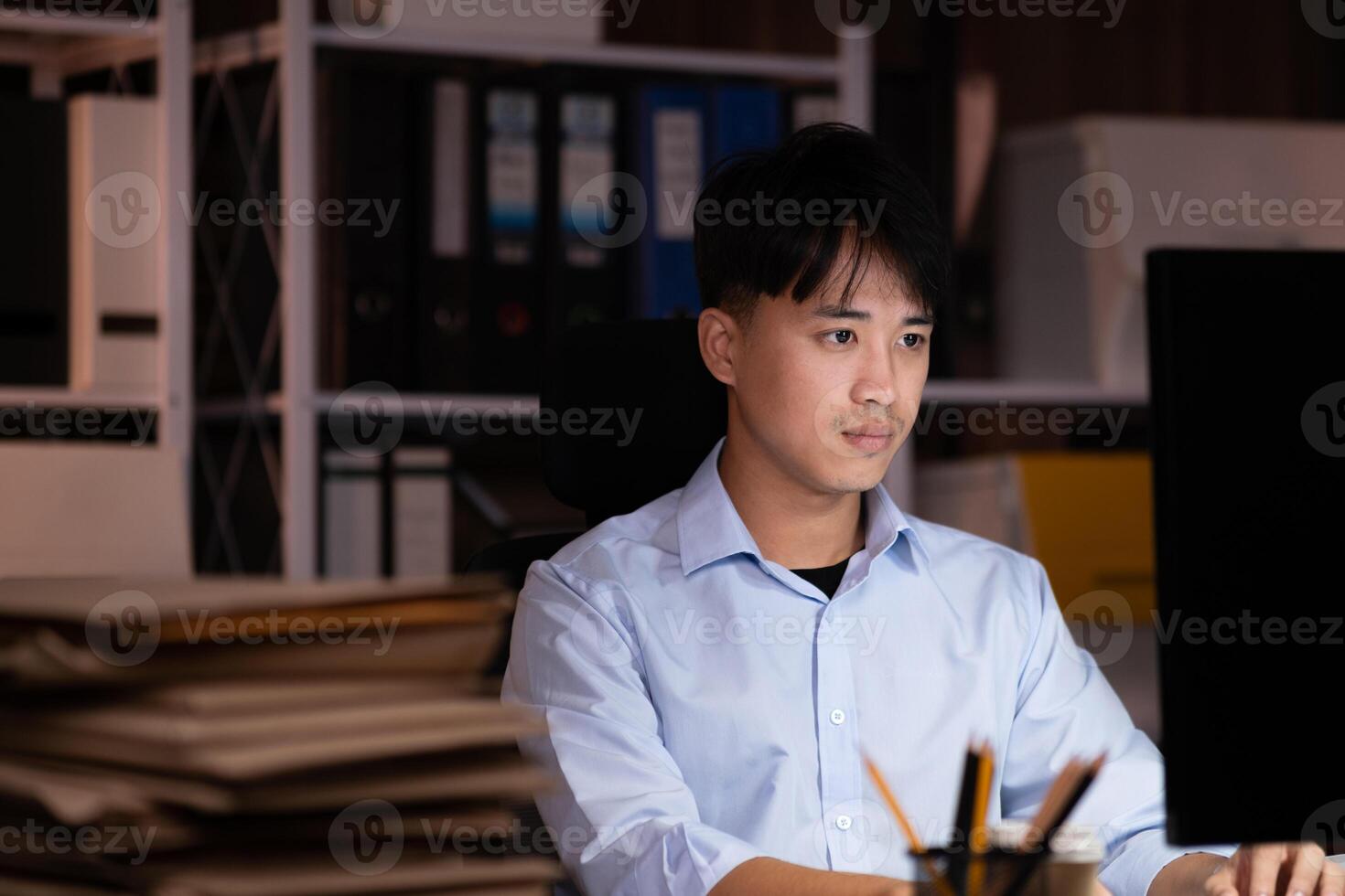 Businessman working overtime at his office He felt tired. photo