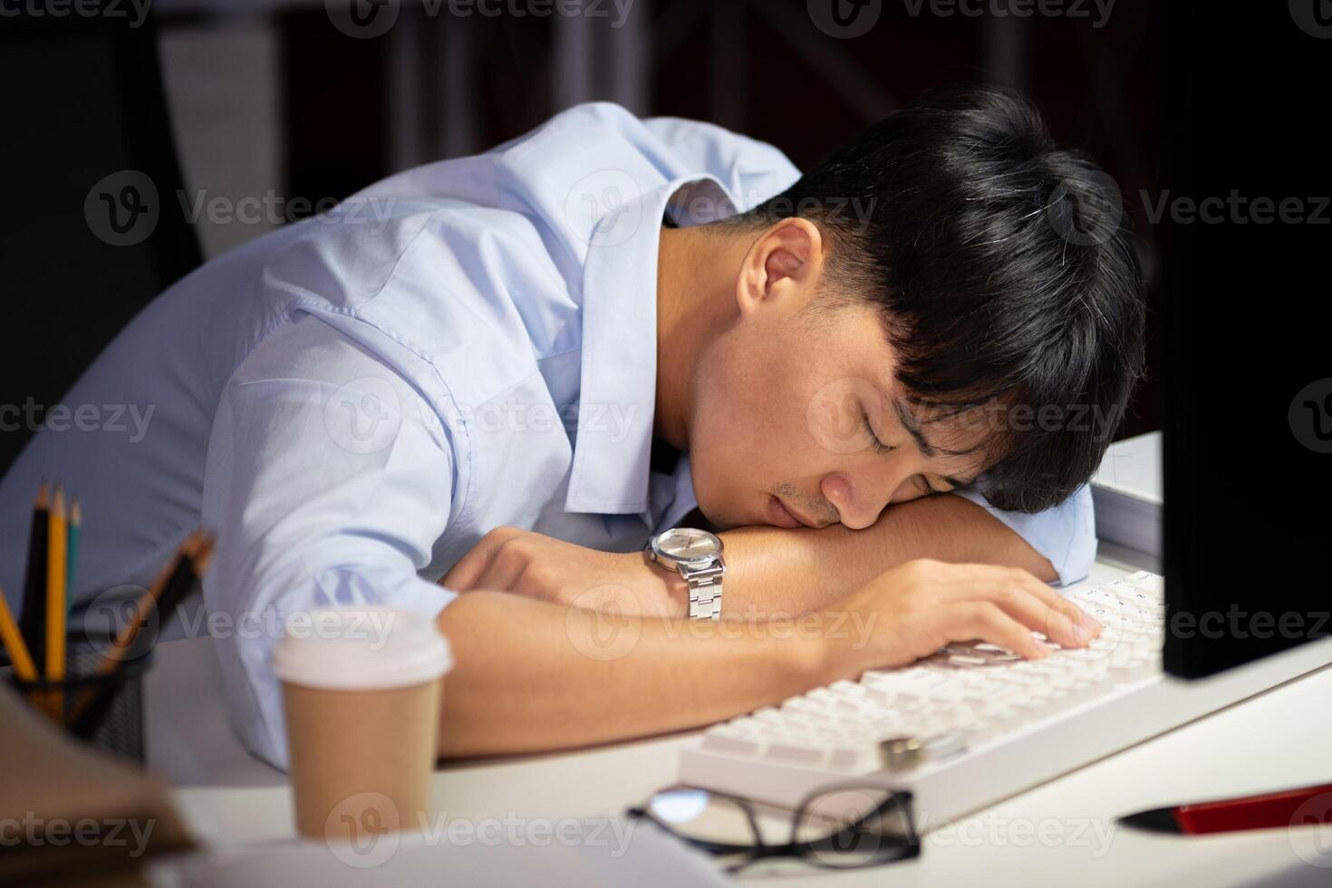 Businessman working overtime at his office He felt tired. photo