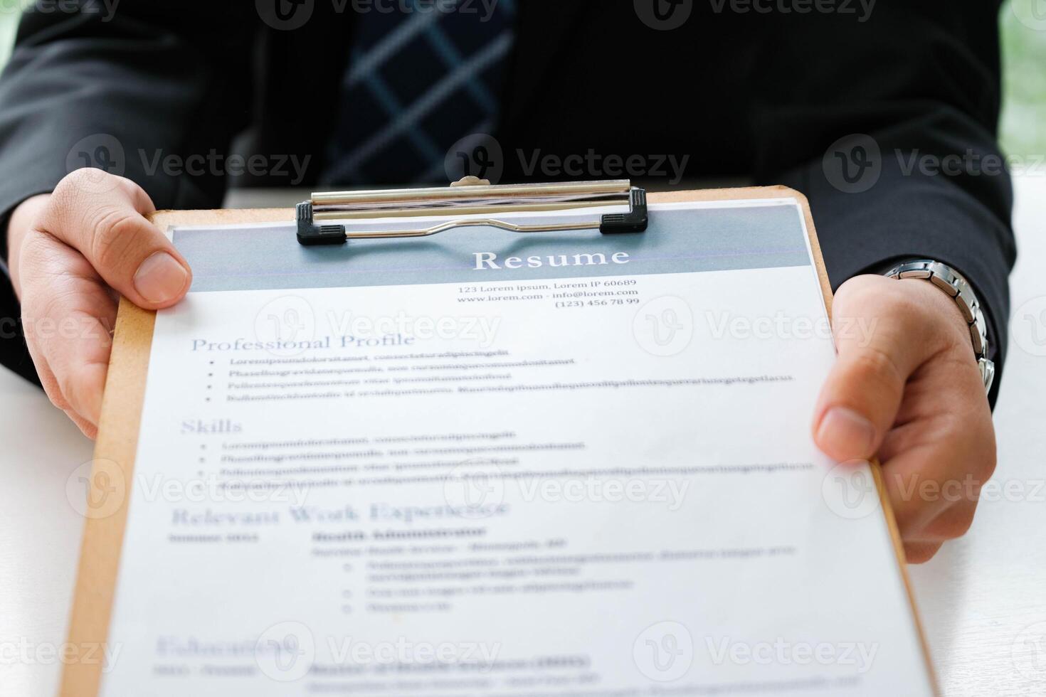 Close-Up of Businessman Holding a Resume. photo
