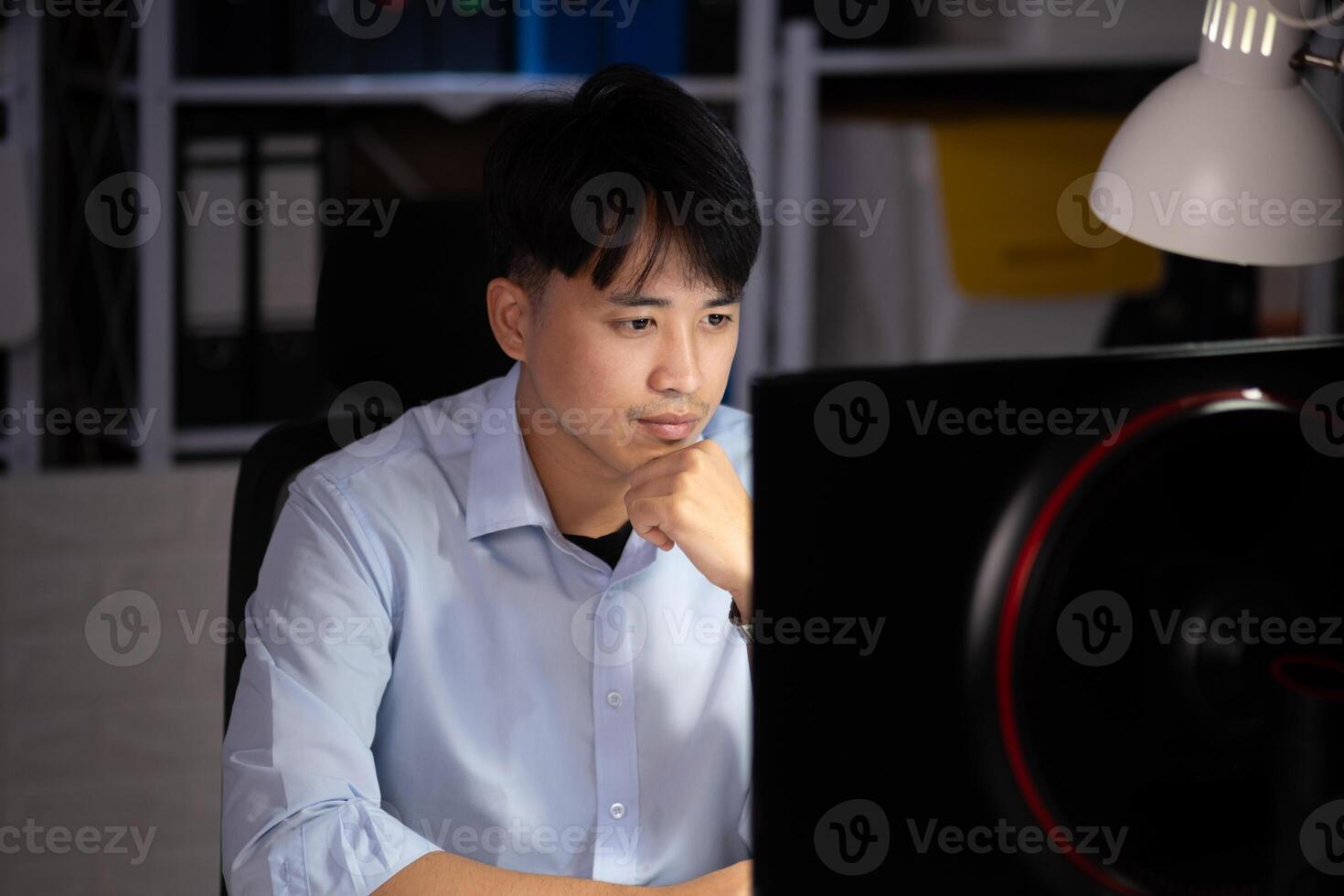 Businessman working overtime at his office He felt tired. photo