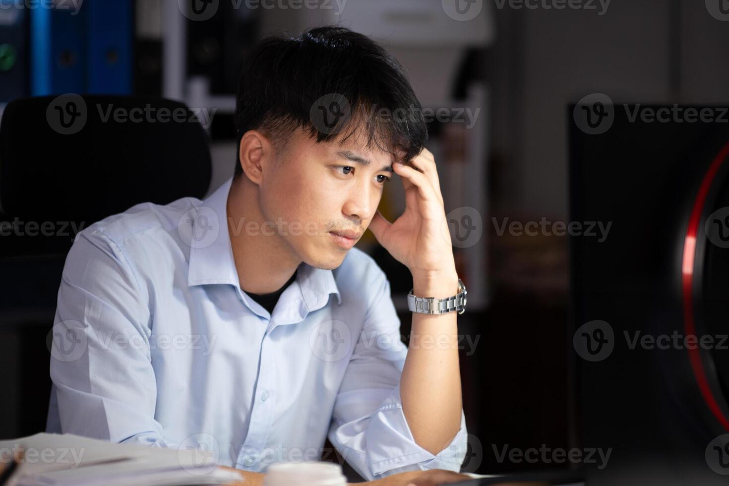 Businessman working overtime at his office He felt tired. photo