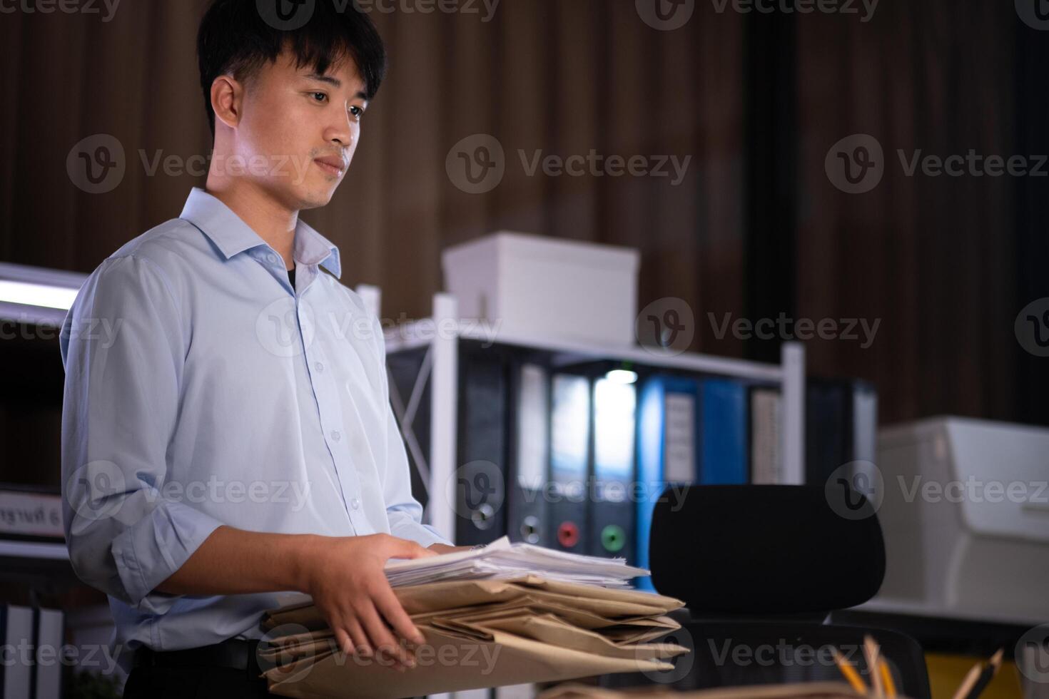 Businessman working overtime at his office He felt tired. photo