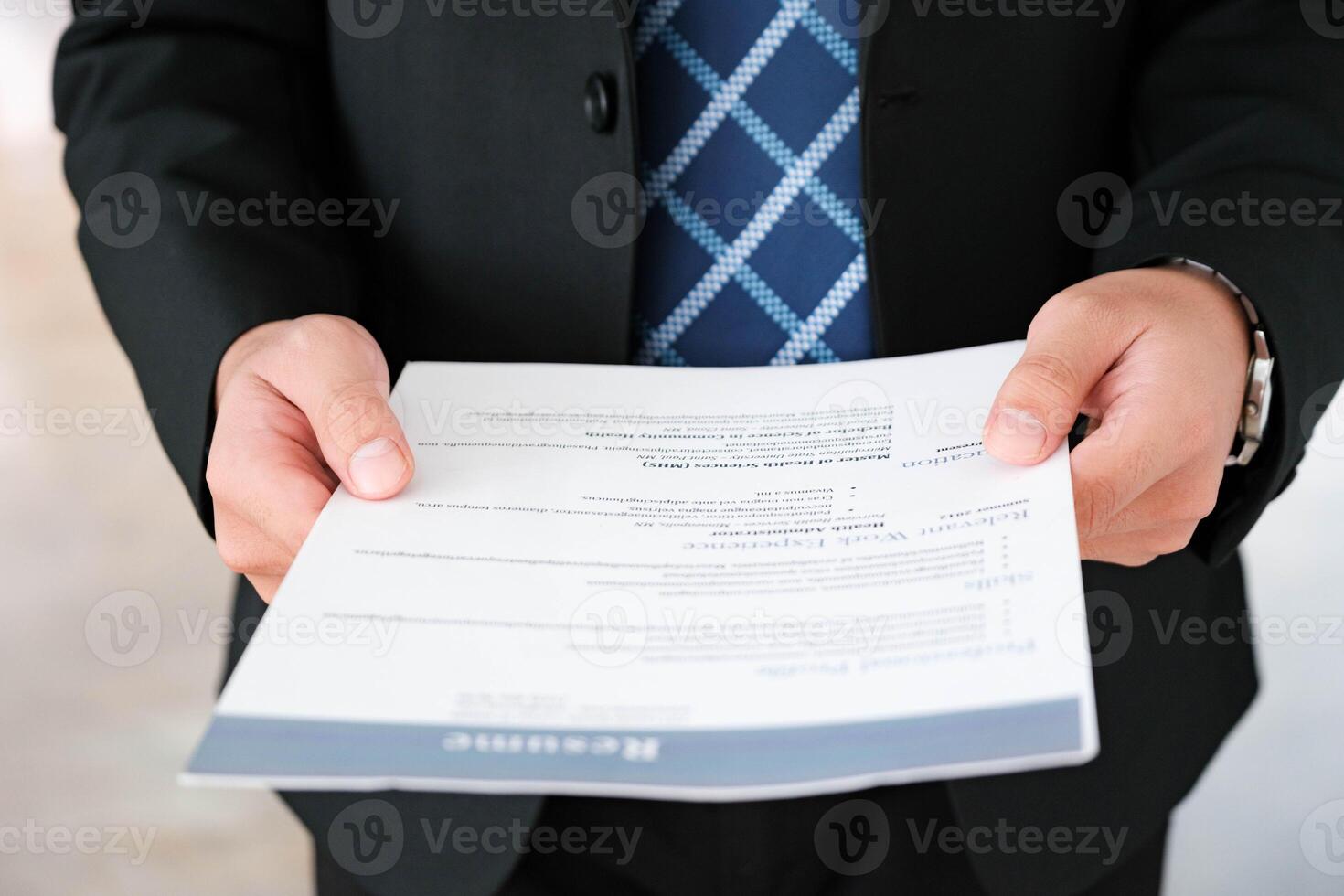 Close-Up of Businessman Holding a Resume. photo