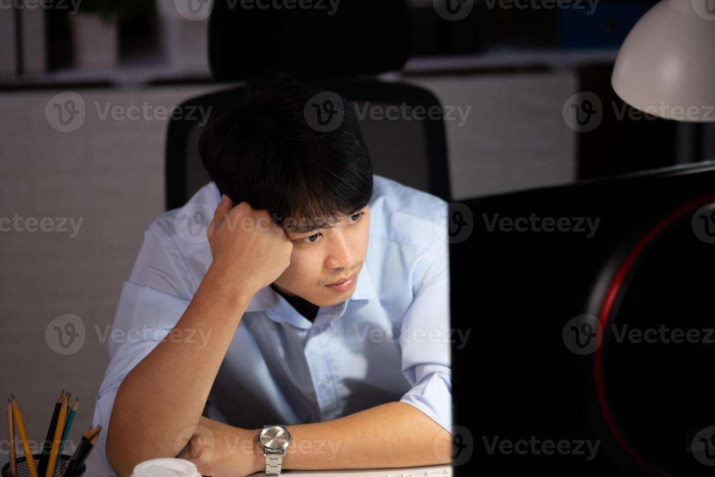 Businessman working overtime at his office He felt tired. photo