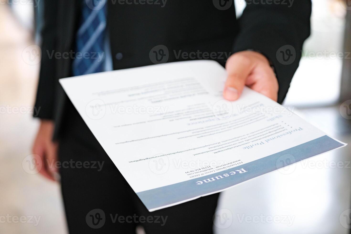 Close-Up of Businessman Holding a Resume. photo