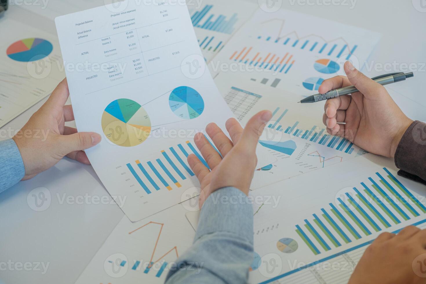 A team of business people is brainstorming to analyze investment project data. photo