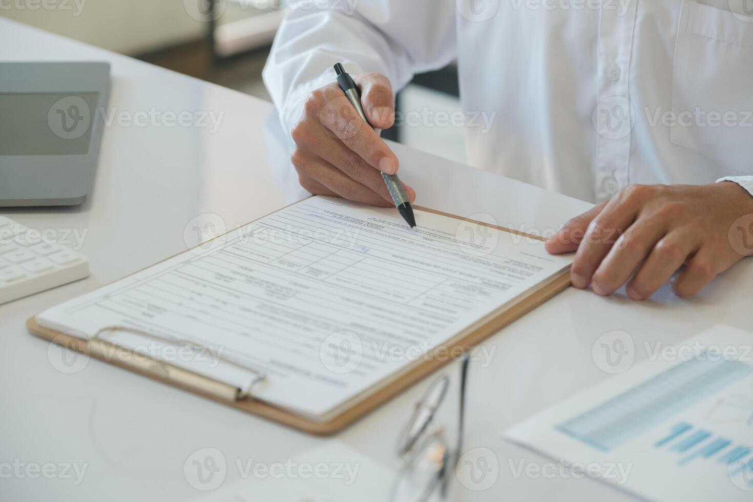 Hands of a businessman about to sign a business contract photo