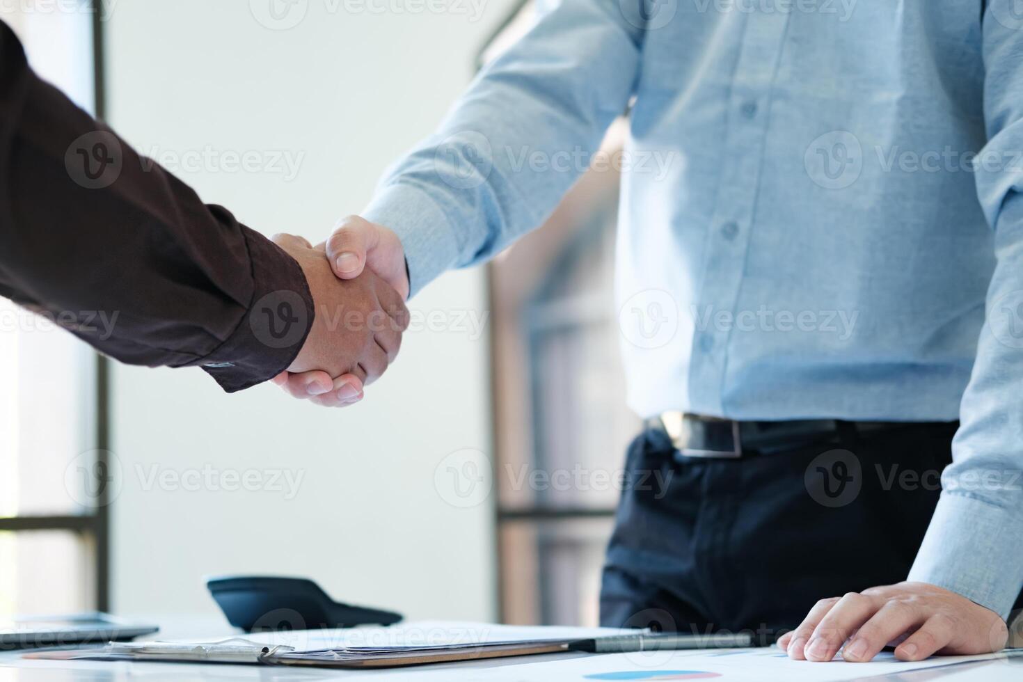 Businessmen shake hands after completing a business deal. photo