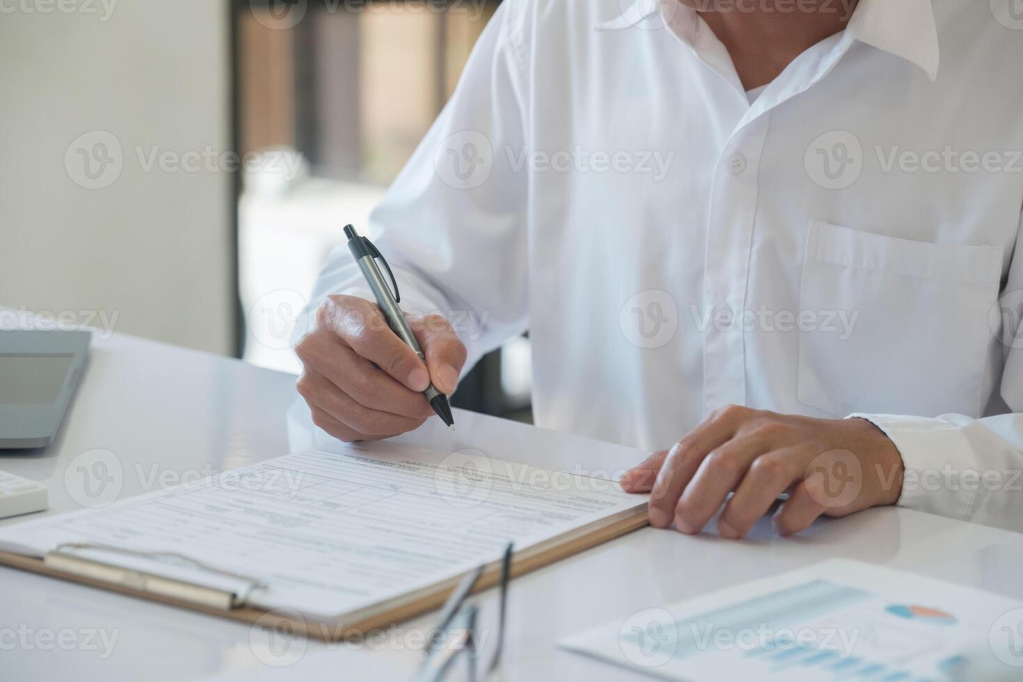 Hands of a businessman about to sign a business contract photo