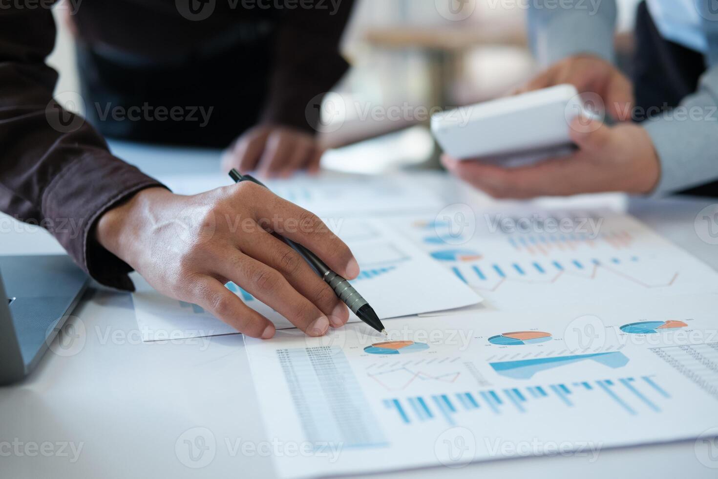 A team of business people is brainstorming to analyze investment project data. photo