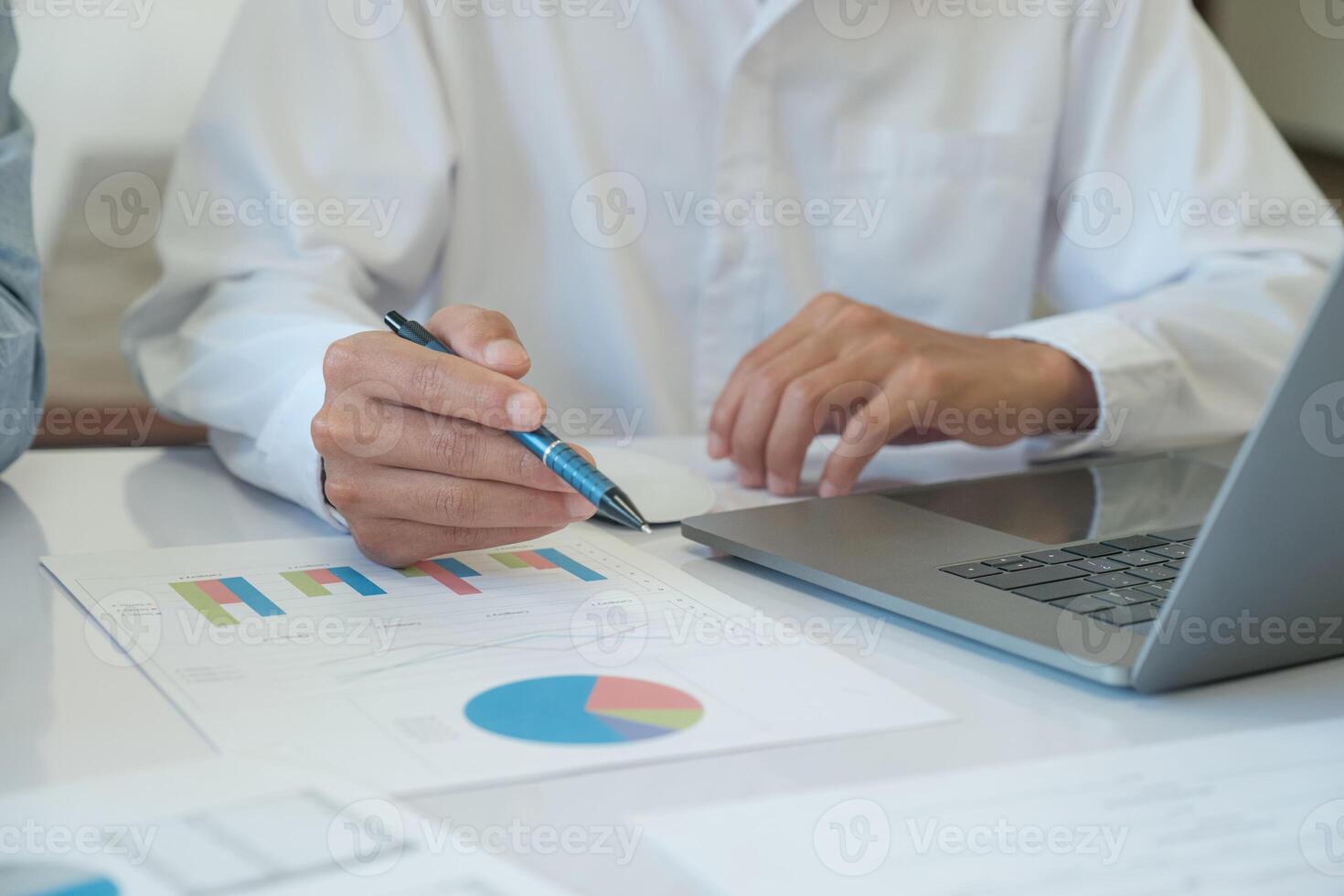 Businessman is analyzing investment data from graph photo