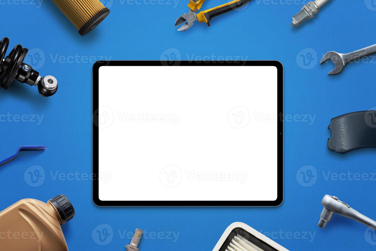 Tablet mockup with isolated screen for app or web page promotion surrounded by car parts and tools. Concept of car service or part sales photo