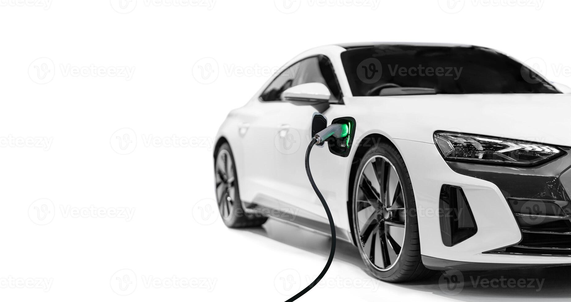 Modern electric car plugged in and charging on a white background photo