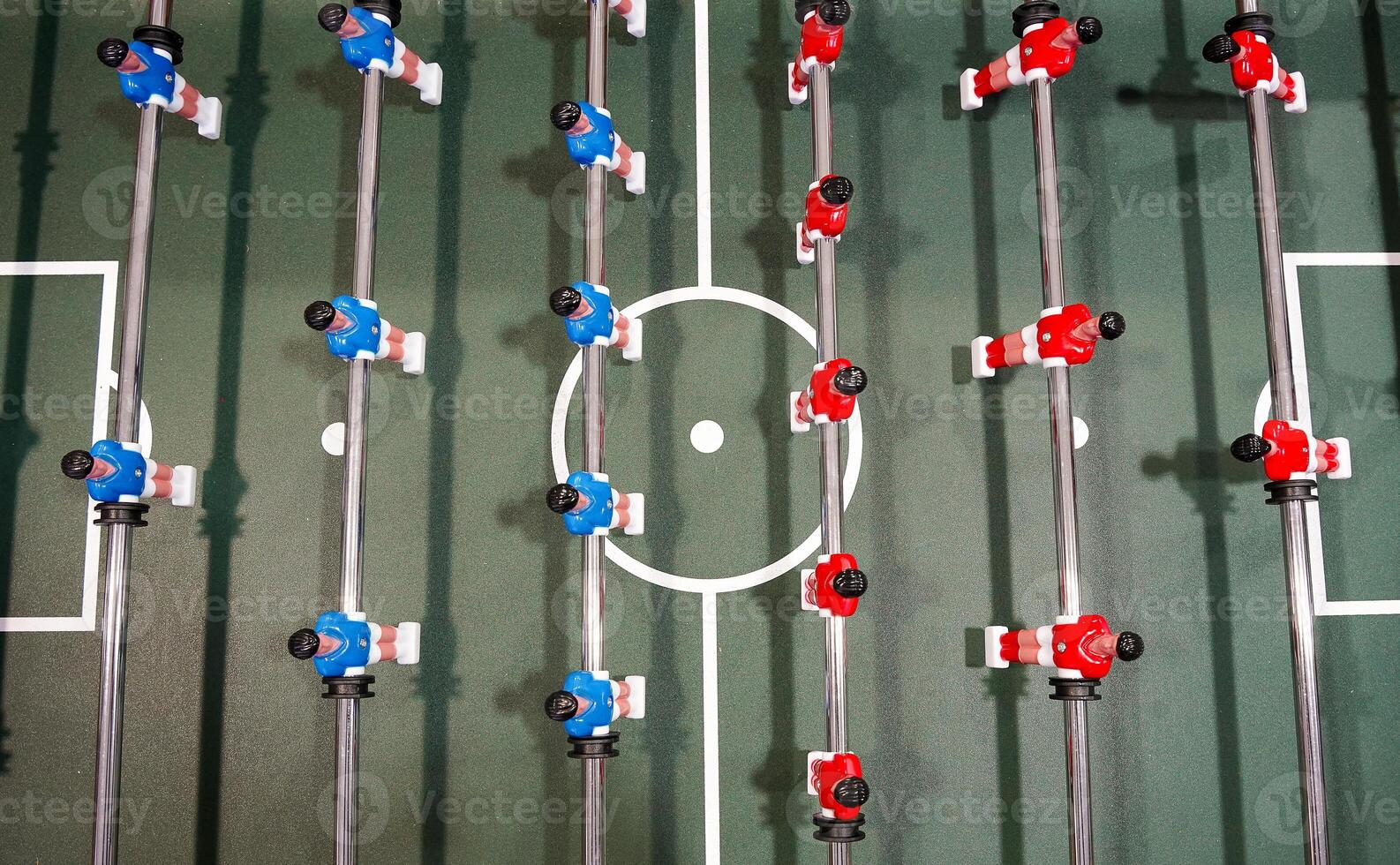 Table football. Green table with little players. Playing football table game. photo