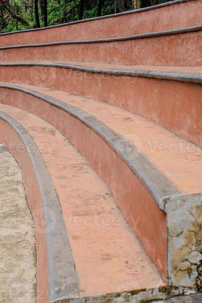 Close-up view of the old curved concrete stairs in the city park. photo