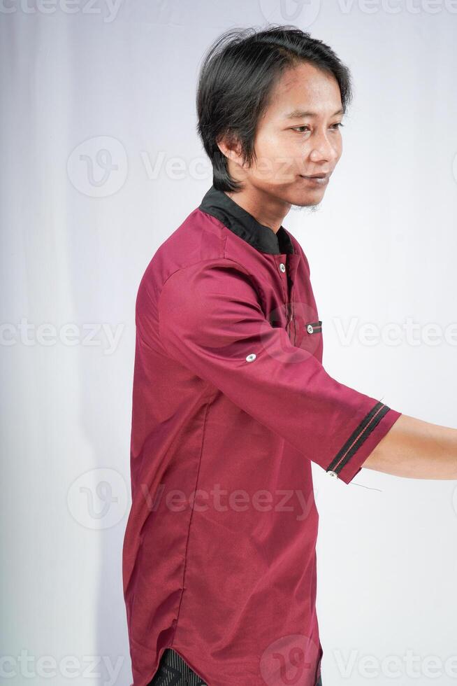 man in koko shirt is extending his hand for a handshake against a white background. photo
