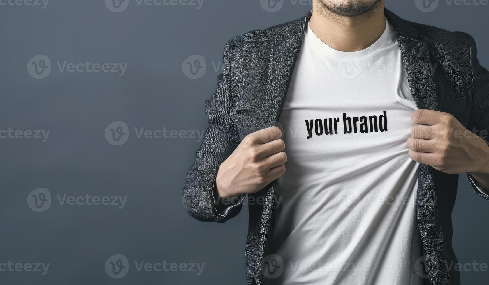 Businessman opening his shirt with the text Build your brand written on a white t-shirt against an isolated background. photo