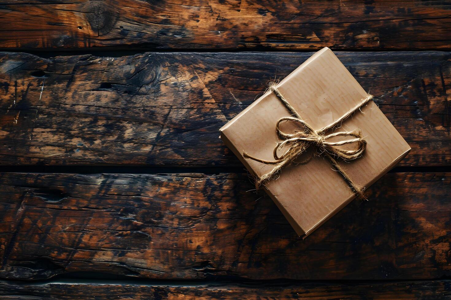 cardboard package box tied with rope on wooden table photo