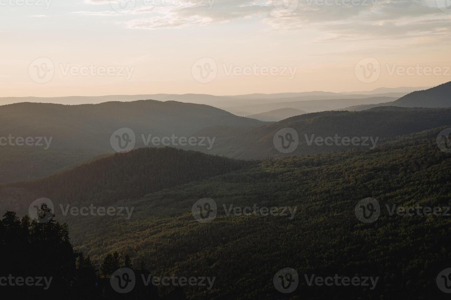Landscape at dusk from a bird's eye view, photo from a drone, Russian taiga, foggy horizon, a lot of forest, coniferous trees.