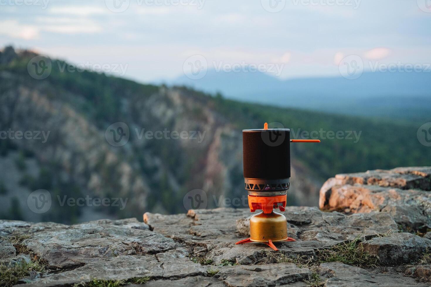 Camping system, ultra-light equipment for climbers, gas burner in nature, pot for food, camping, mountain climbing. photo