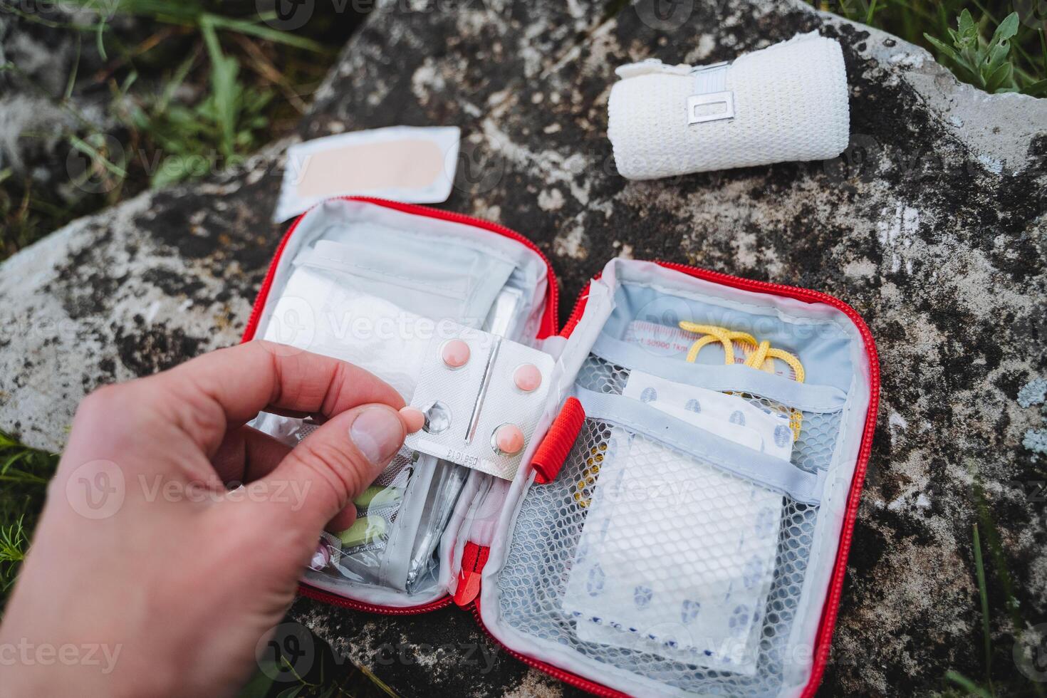 rosado tabletas para abdominal dolor en un caminata, primero ayuda equipo para viajar, primero ayuda equipo, cámping equipo, un conjunto de medicamentos es en el bolso foto