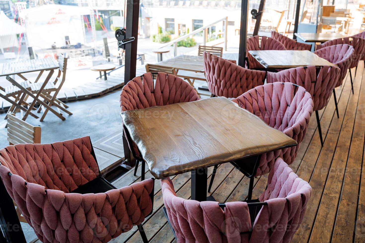 Restaurant on the street, beautiful interior of the cafe in the city, tourist place of rest, morning breakfast in the fresh air. soft armchairs photo