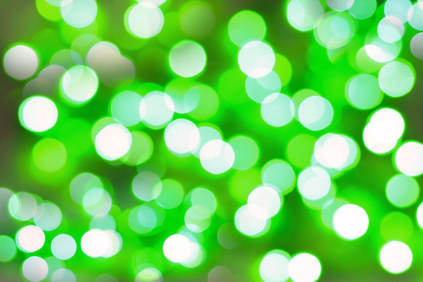 Blurred bokeh magical background. Green and white gradient. Shimmer confetti pattern. Abstract christmas and new year holidays effect. Festive blue luminous background. photo