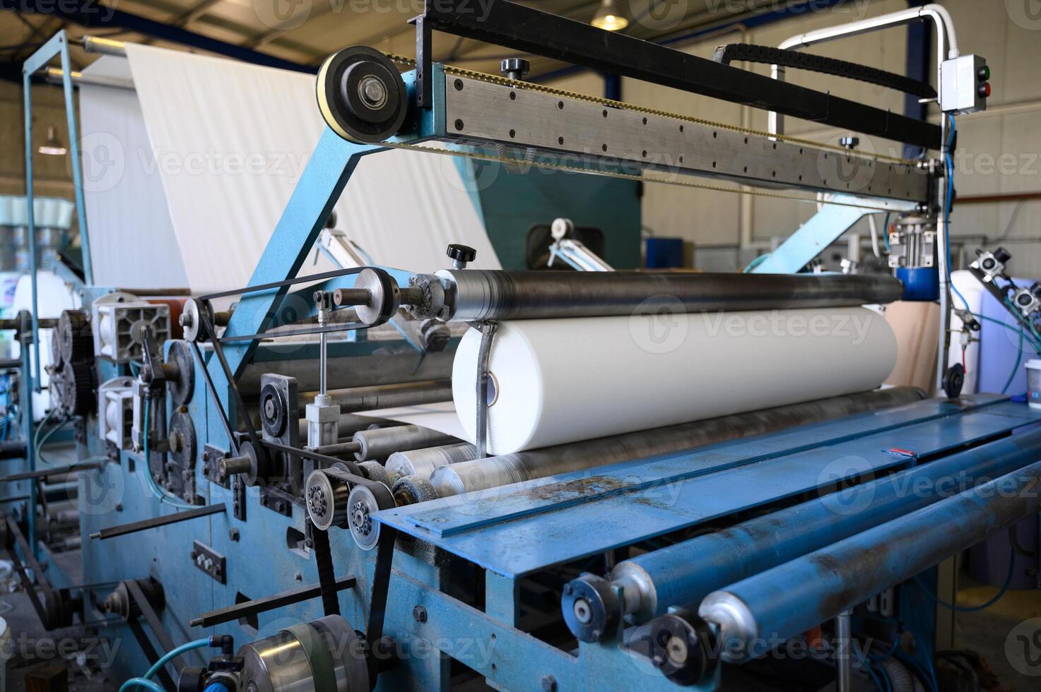 Greek factory for the production of paper rolls for hygiene. Manufacture of paper towels and toilet paper. Roll winding machine. photo