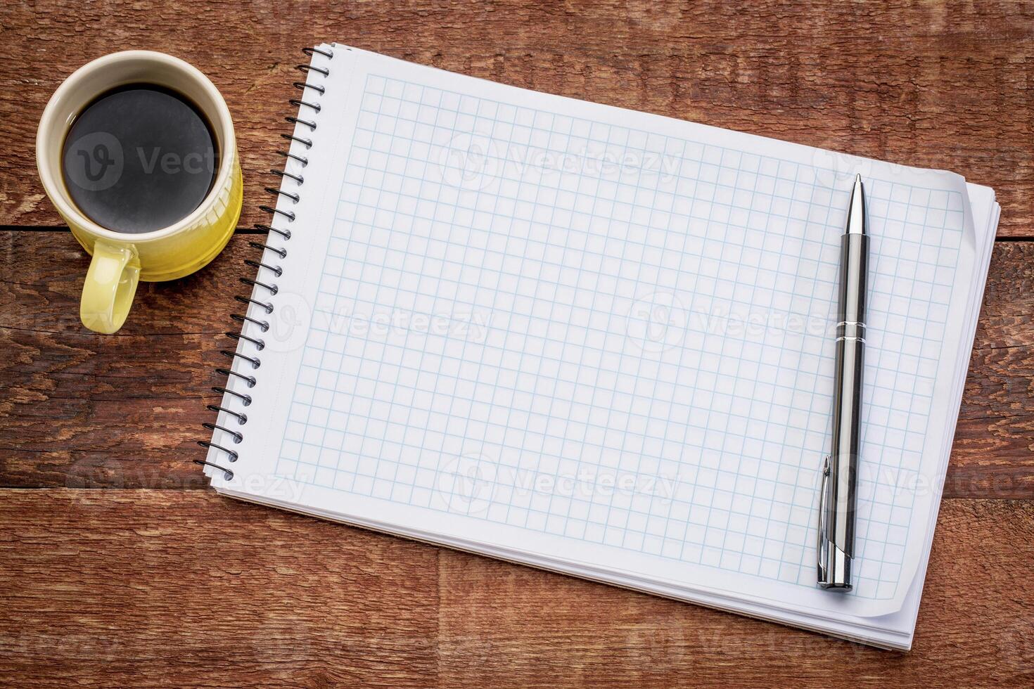 blank spiral notebook and coffee photo