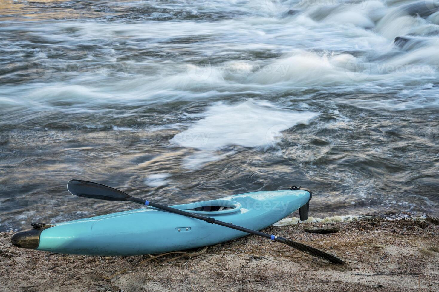 kayak on river shore photo