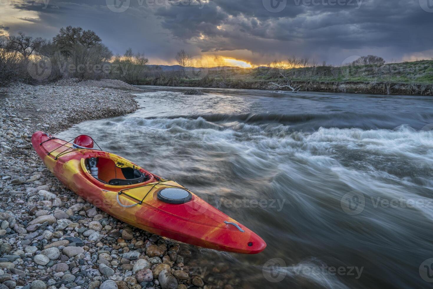 whitewater kayak at sunset photo