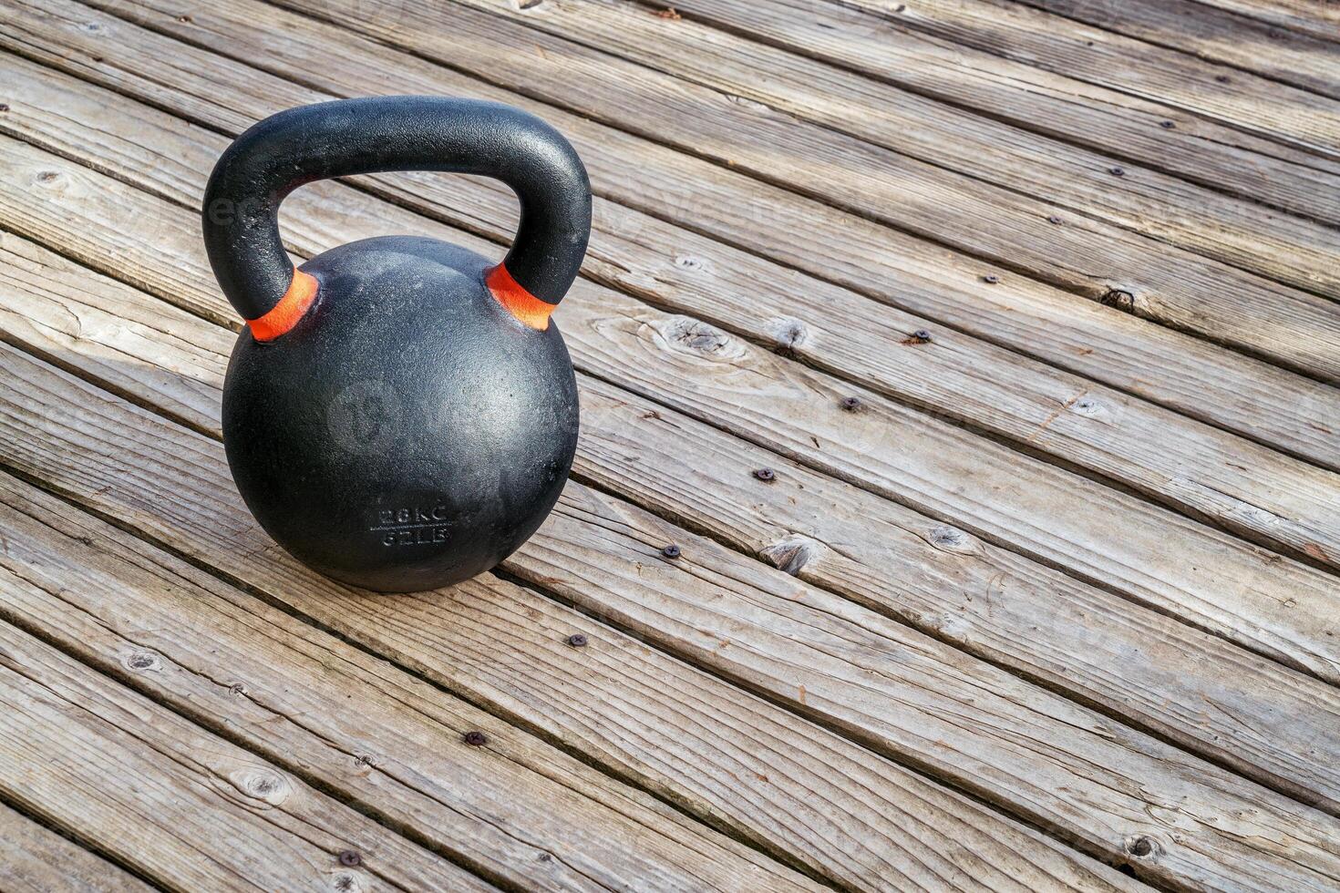 iron kettlebell on wood deck photo