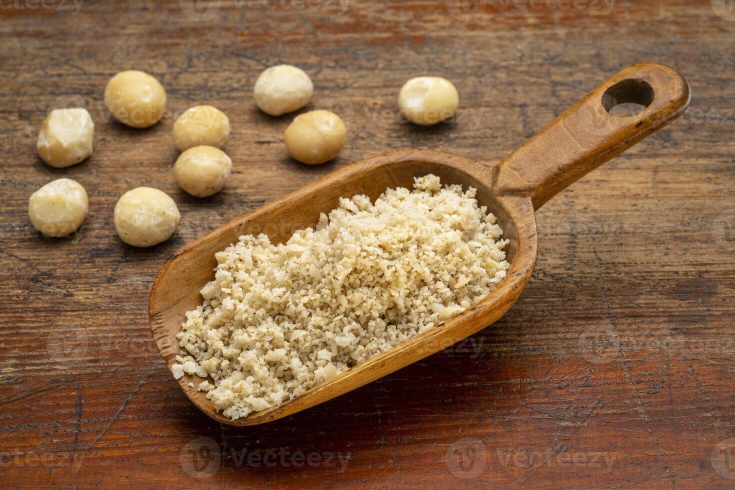 macadamia nut flour in wooden scoop photo