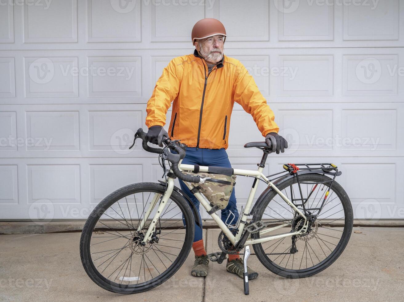 senior make cyclist with touring bike photo