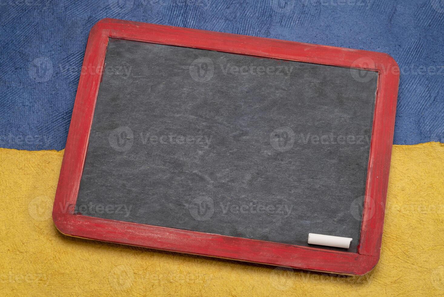 blank blackboard against bluae and yellow photo